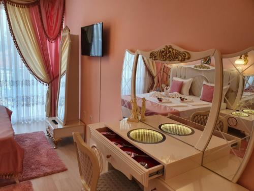 a bedroom with a bed with a large mirror at Hotel Dalia - Bankya in Bankya
