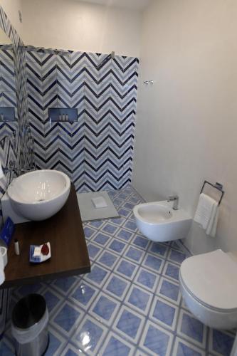 a bathroom with a toilet and a bidet at Palazzo San Giovanni Amalfi Coast in Scala