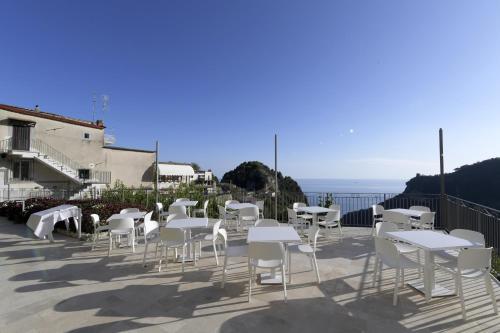 a group of white tables and chairs on a patio at Palazzo San Giovanni Amalfi Coast in Scala