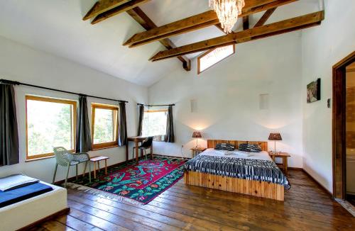 a bedroom with a bed and a rug at Herzegovina Lodges Boracko Jezero in Konjic
