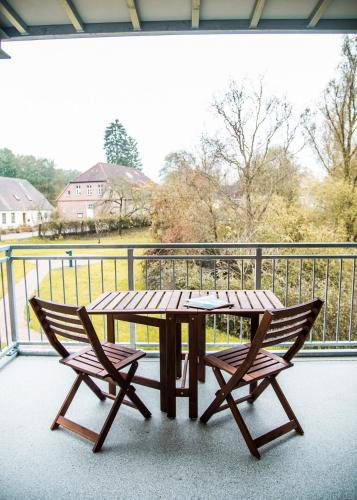a wooden table and two chairs on a balcony at Apartmenthaus Feldberg in Feldberg