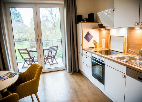 a kitchen with a balcony with a table and chairs at Apartmenthaus Feldberg in Feldberg