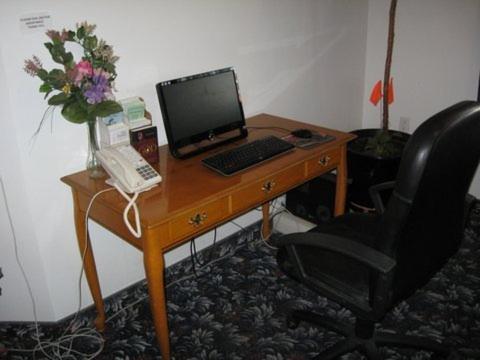 a desk with a laptop computer on it at Glacier Gateway Plaza in Cut Bank