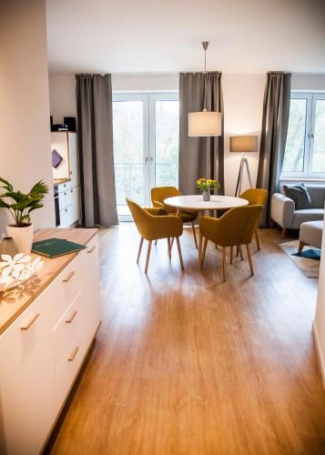 a kitchen and living room with a table and chairs at Apartmenthaus Feldberg in Feldberg