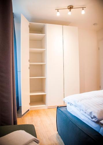 a bedroom with a bed and a closet at Apartmenthaus Feldberg in Feldberg