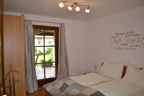 a bedroom with a bed and a window at Gästehaus Reingruber in Ried im Traunkreis
