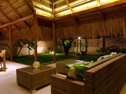 a living room with two couches and a patio at Halamanan Residences in Panglao