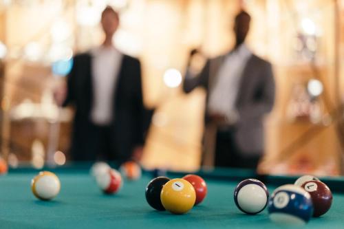 a group of billiard balls on a pool table at Everness Hotel & Resort in Chavannes-de-Bogis