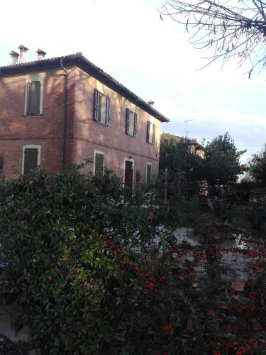 a large brick building with a bunch of flowers at B&B Marana 14 Casa di Campagna in Bologna