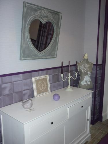 a white dresser with a mirror on the wall at Villa Étienne in Le Mont-Dore