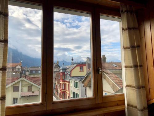 a window with a view of the city at central beauty scenery apartment in Interlaken