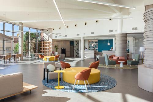 a lobby with chairs and tables in a building at Abora Interclub Atlantic by Lopesan Hotels in San Agustin