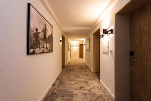 a corridor of a hallway with a painting on the wall at Hotel Brugger in Fulpmes