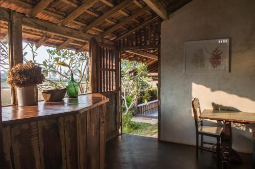 a kitchen with a counter and a table in a room at The Artist Cottages in Morjim