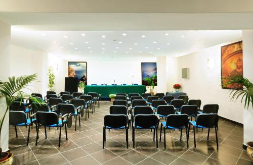 a room with a row of chairs and a stage at Alberi del Paradiso in Cefalù
