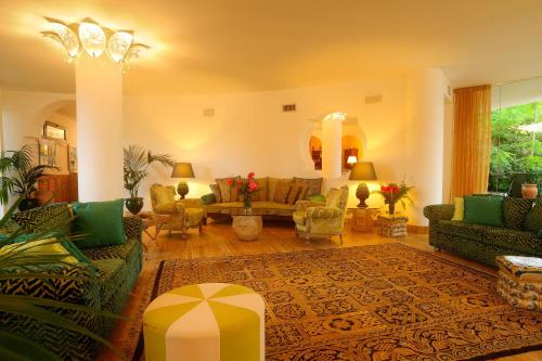 a large living room with couches and a rug at Alberi del Paradiso in Cefalù