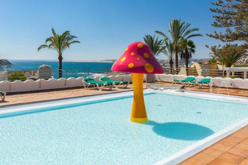 a toy mushroom in the water next to a swimming pool at Abora Interclub Atlantic by Lopesan Hotels in San Agustin