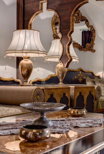 a table with a lamp and a mirror at Tuvana Hotel in Antalya