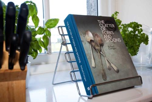 a book of forks and spoons sitting on a counter at Ardnave in Port Charlotte