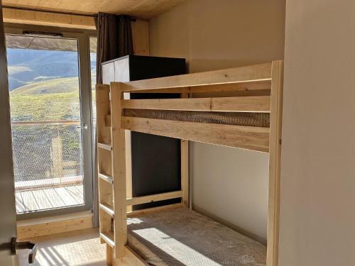 a bunk bed in a room with a window at Lagrange Vacances L’Écrin du Badet in Aragnouet