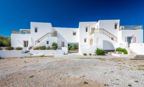 a large white house with a driveway at Milia Gi Suites in Pollonia