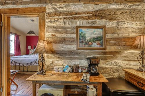 a room with a wooden wall with a table and a bedroom at Historic Rocky Hill in Fredericksburg