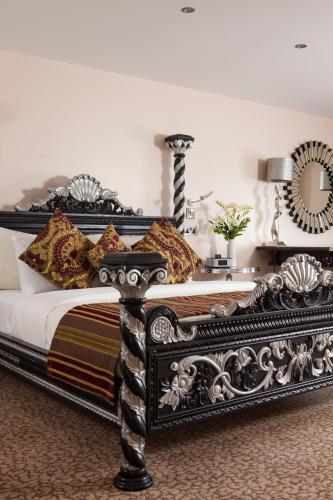 a black bed with pillows on it in a bedroom at Best Western Premier Doncaster Mount Pleasant Hotel in Doncaster