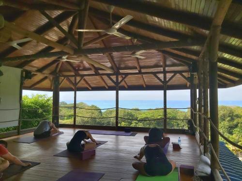 a group of people doing yoga in a building at Horizon Hotel & Yoga Center in Santa Teresa Beach