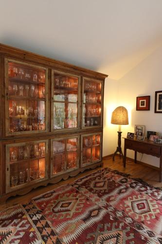 a room with a large wooden cabinet with glass doors at Quinta da Ferradosa Wines in São João da Pesqueira
