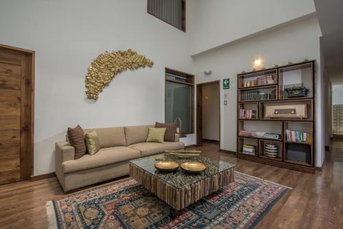 a living room with a couch and a coffee table at Casa Esmeralda by Katari in Cusco