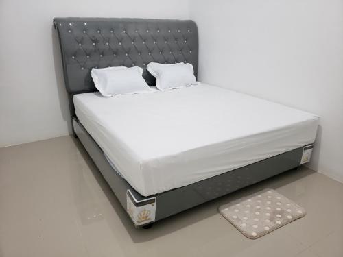 a bed with two pillows on top of it at Brand new vacation house- Private gated community in Banda Aceh