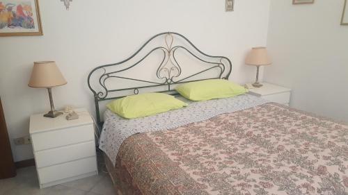 a bedroom with a bed with two night stands and two lamps at casa roberta e gilberto in Bologna