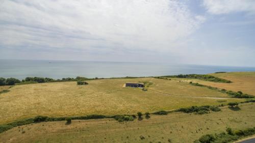an open field with a house on top of it at The Old Signal House in Niton