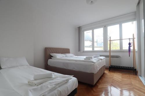 a bedroom with two beds and a window at Old Town Premium Apartment in Sarajevo