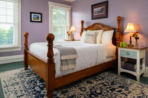 a bedroom with a large bed with a wooden frame at Steeles Tavern Manor in Steeles Tavern
