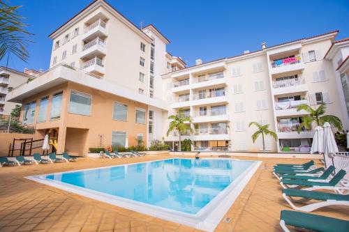 a swimming pool in front of a building at FLH Funchal Modern Apartment with Pool in Funchal