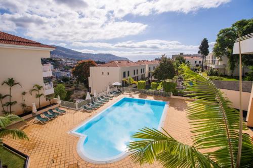a swimming pool on a patio with a view of a city at FLH Funchal Modern Apartment with Pool in Funchal