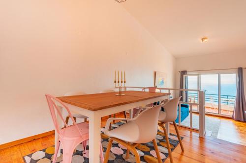 a dining room with a table and chairs at FLH Funchal Ocean View with Pool in Funchal