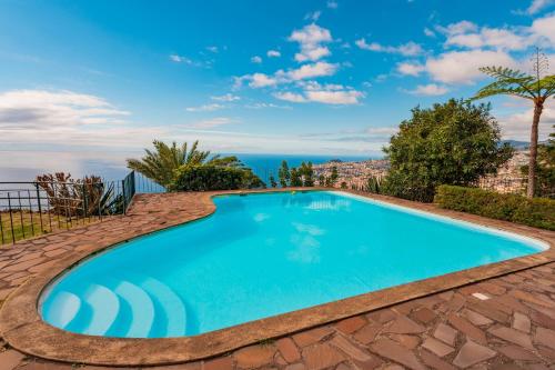 a swimming pool with a view of the ocean at FLH Funchal Ocean View with Pool in Funchal