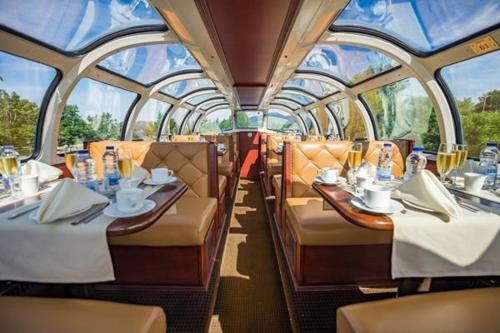 a dining car of a train with tables and chairs at Splendid Mountain View Condo with Pool & BBQ- Ski, MTB, Cycling, Golf, Telework! in Bromont