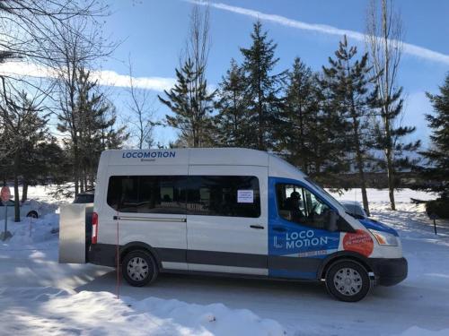 a white and blue van parked in the snow at Splendid Mountain View Condo with Pool & BBQ- Ski, MTB, Cycling, Golf, Telework! in Bromont