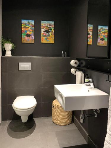 a bathroom with a white sink and a toilet at Wex 1 Apartments in Cape Town