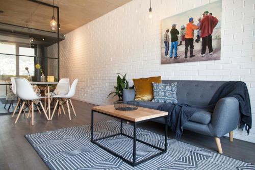a living room with a blue couch and a table at Wex 1 Apartments in Cape Town