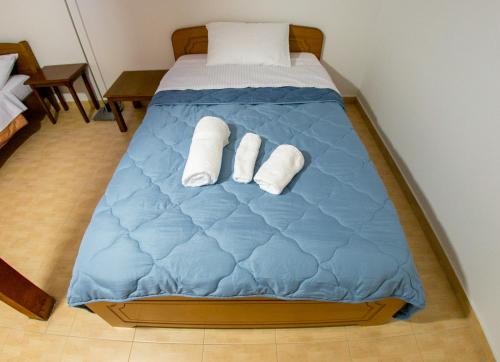a bed with two rolled up towels on it at Vier Luxury House in Serres