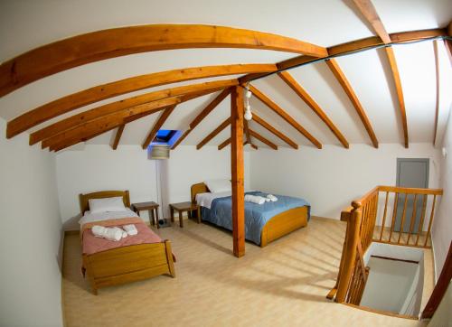 a attic room with two beds and a table at Vier Luxury House in Serres