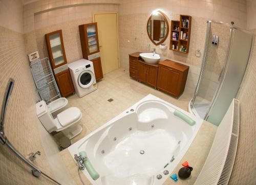a large bathroom with a tub and a shower at Vier Luxury House in Serres
