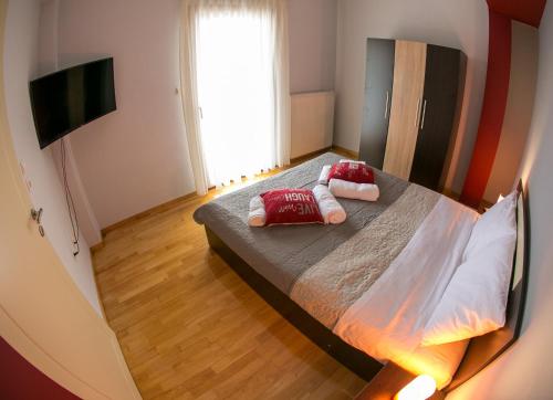 a bedroom with a bed with two pillows on it at Vier Luxury House in Serres