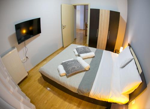 a bedroom with a large bed and a flat screen tv at Vier Luxury House in Serres