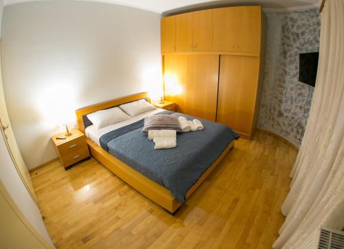 a bedroom with a bed with two towels on it at Vier Luxury House in Serres