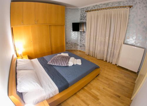 a bedroom with a bed with two towels on it at Vier Luxury House in Serres